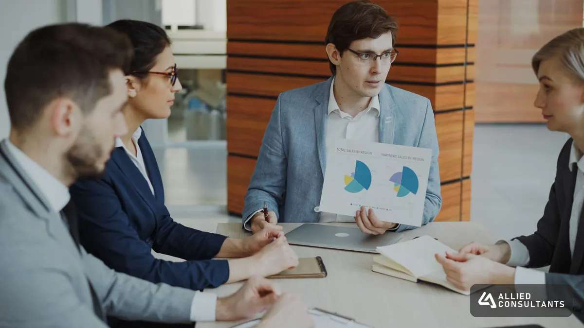 Business team reviewing sales and cash data in a meeting room