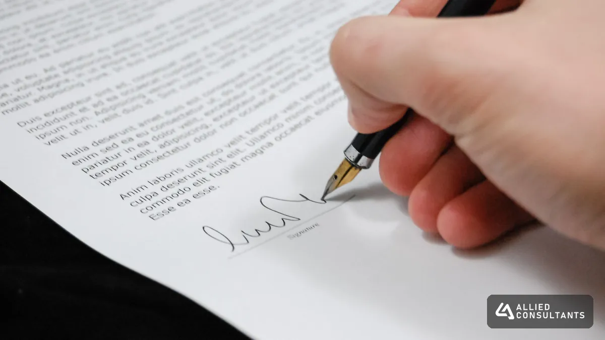 Close up of a hand signing a sale document with a fountain pen