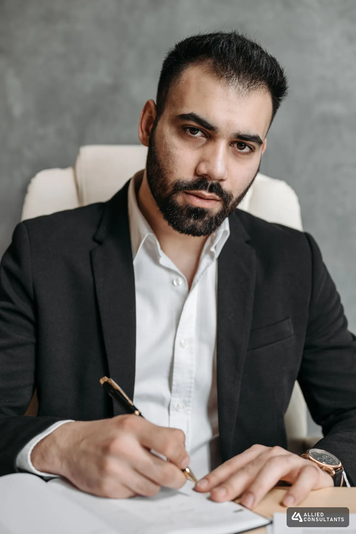 Business owner in a suit reviewing financial documents before a sale