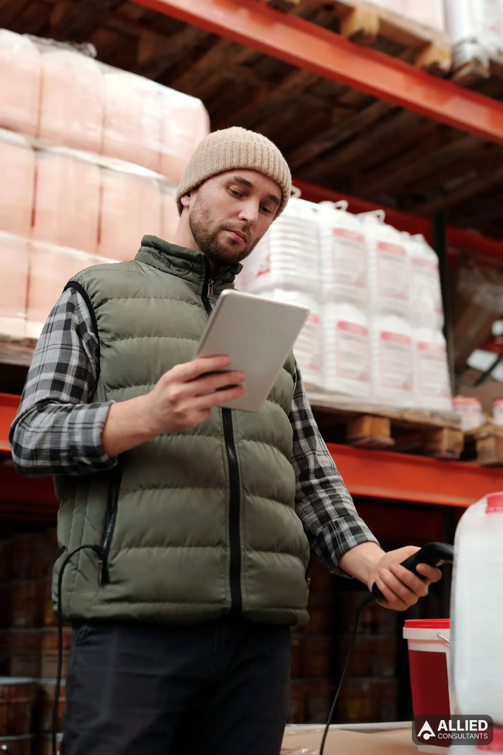 Warehouse employee using a tablet to check stock levels during an inventory count